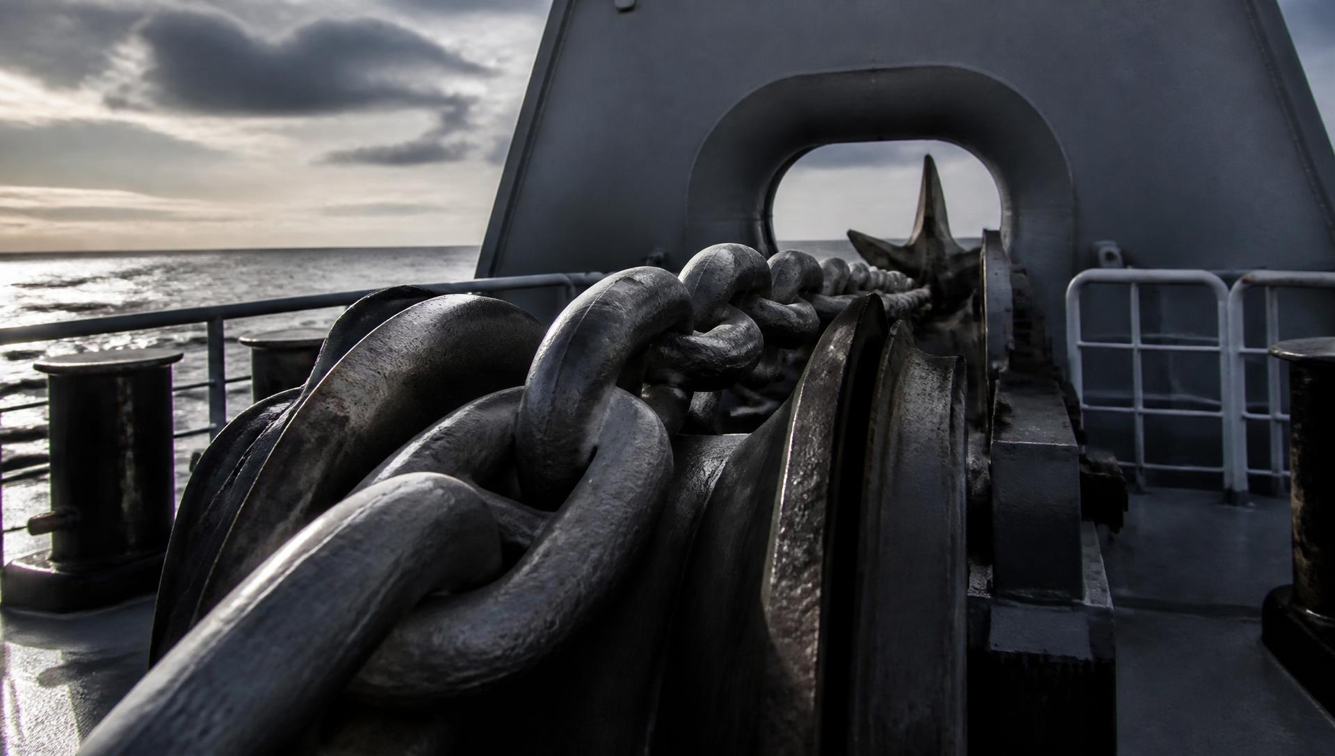 Ship anchor chain running over the windlass on a vessel forecastle